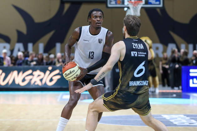 September 4, 2026, xgox, Basketball Exhibition Game: Basketball, Löwen Braunschweig vs. Bamberg Baskets, emspor, from left: Trevon Scott (Bamberg), No. 13 with the ball, playing the ball (Braunschweig)