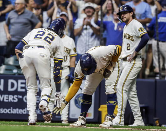 Milwaukee Brewers designated hitter Christian Yelich celebrates with Milwaukee Brewers catcher William Contreras (C) and Milwaukee Brewers second baseman Brice Turang (R) after driving them in with a three RBI hoime run in the first inning of the MLB, Baseball Herren, USA game between the Chicago Cubs and the Milwaukee Brewers at American Family Field in Milwaukee, Wisconsin on Wednesday, September 9, 2026.  MIL20260909808 TANNENxMAURY