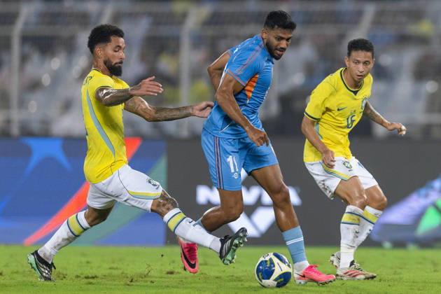 KOLKATA, INDIA - OCTOBER 3: Douglas Luiz Soares de Paulo of Brazil and Rahim Ali of India duel for the ball during friendly match between India and Brazil at the Vivekananda Yuba Bharati Krirangan (VYBK) Stadium in Kolkata, India on 3rd October, 2026 Copyright: xUnnatixNaidux Sportspressphoto_SPR245233