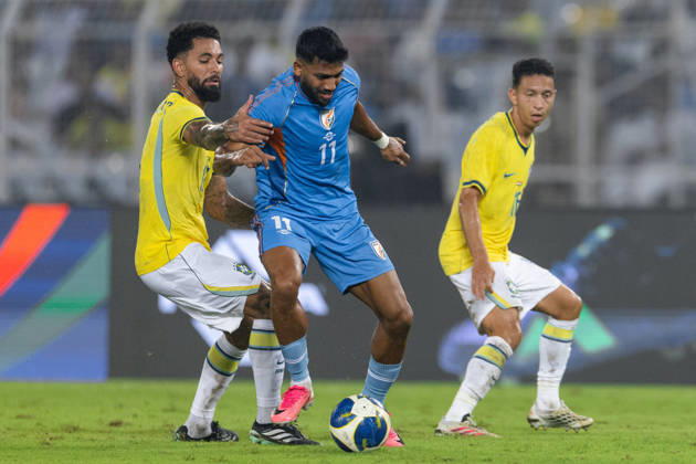 KOLKATA, INDIA - OCTOBER 3: Douglas Luiz Soares de Paulo of Brazil and Rahim Ali of India duel for the ball during friendly match between India and Brazil at the Vivekananda Yuba Bharati Krirangan (VYBK) Stadium in Kolkata, India on 3rd October, 2026 Copyright: xUnnatixNaidux Sportspressphoto_SPR245234