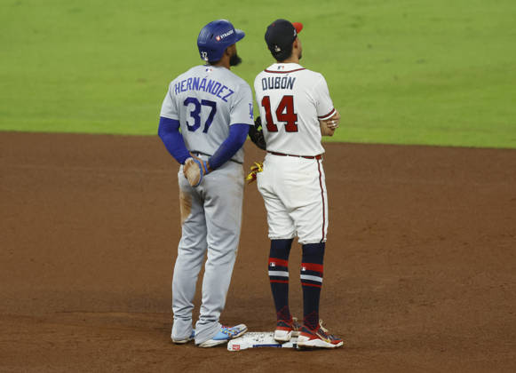 Los Angeles Dodgers Teoscar Hernandez (37) and Atlanta Brave Mauricio Dubon (14) watch a replay review after a call on second base in the sixth inning in an MLB, Baseball Herren, USA National League Division Series playoff game at Truist Park in Atlanta, Georgia, on Wednesday, October 7, 2026.  ATL20261007718 MIKExZARRILLI