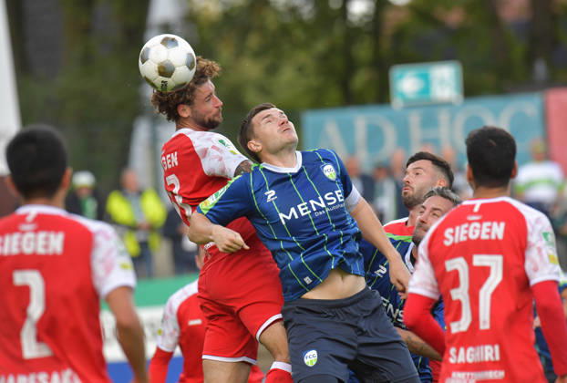 October 10, 2026, GER, Soccer, Regionalliga West, 2026–2027 Season, Matchday 12, Ohlendorf Stadium in Heidewald, Gütersloh FC vs. SF Siegen 0–5, Björn Rother (FC Gütersloh, right) vs. Jan Luca Rumpf (SF Siegen), action, duel, tackle, header
