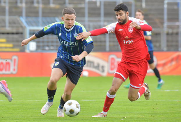 October 10, 2026, Germany, Soccer, Regionalliga West, 2026–2027 Season, Matchday 12, Ohlendorf Stadium in Heidewald, Gütersloh FC vs. SF Siegen 0–5, Phil Beckhoff (FC Gütersloh, left) vs. Hamza Saghiri (SF Siegen), action, duel, tackle