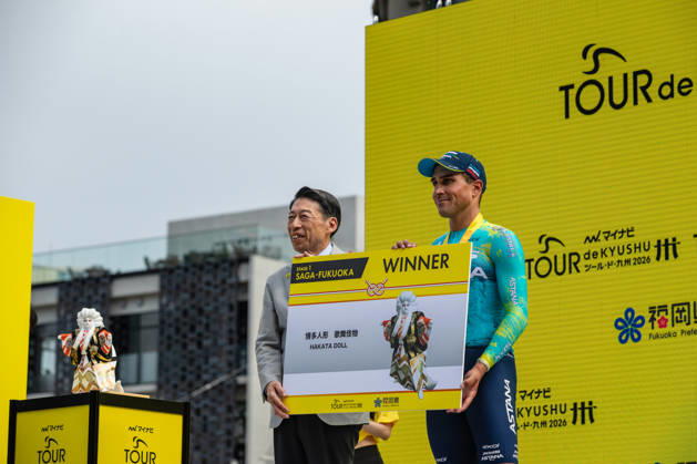 Tour De Kyushu Stage Finishes In Fukuoka s Tenjin For The First Time Matteo Malucelli of XDS Astana Team wins Stage 1 of the Mynavi Tour de Kyushu 2026 at the finish line on Tenjin Bridge in Fukuoka, Japan, on October 10, 2026. The Italian won the 152.0-kilometer Saga-Fukuoka stage in 3 hours 9 minutes 51 seconds, ahead of Luke Mudgway (Li Ning Star) and Alessio Delle Vedove (XDS Astana Team), and took the general and points classification leads. It was the first time the race finished in Tenjin, the commercial heart of Fukuoka, where a parade, stage events and food stalls marked the day. The race, first held in 2023 and part of the UCI Asia Tour (2.1 category), runs October 9-12 through six Kyushu prefectures under the official title We stand with Kumamoto. Mynavi Tour de Kyushu 2026, adopted to support areas affected by the Kumamoto earthquake. Fukuoka Japan  Copyright: xRyoxChix originalFilename:zhi-tourdeky261010_np9X6.jpg