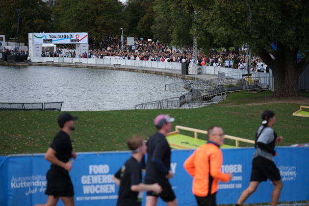 Munich Marathon 2026 MUNICH, GERMANY - OCTOBER 11: Runners pass along a course beside a lake as a large crowd of spectators gathers near the finish line in the background during the 2026 Munich Marathon in Munich, Germany on October 11, 2026. The finish line, marked with a You made it! banner, is set within the Olympic Park. Merve Goettl Anadolu Munih Germany. Editorial use only. Please get in touch for any other usage.  Copyright: x2026xAnadoluxMervexGoettlx