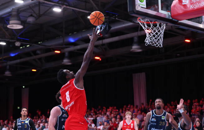 Nat Diallo of RheinStars Cologne 08 shooting a basket; Garai Zeeb of Eisbären Bremerhaven 03 and Jeremiah Oden of Eisbären Bremerhaven 25 watching; GER, RheinStars Cologne vs. Eisbären Bremerhaven, Basketball, ProA, Matchday 4, 2026–2027 season, October 11, 2026 GER, RheinStars Cologne vs. Eisbären Bremerhaven, Basketball, ProA, Matchday 4, 2026–2027 season, October 11, 2026, RheinStars Cologne Copyright: xEibner-Pressefoto ThomasxStoeckerx EP_TSR