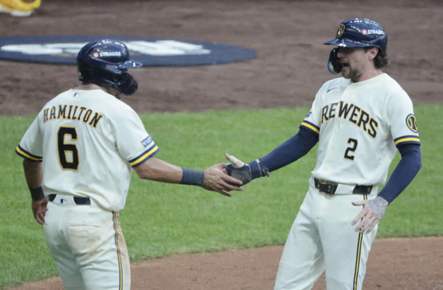 Milwaukee Brewers Brice Turang (2) is congratulated by David Hamilton (6) after scoring on a third inning single by Christian Yelich against the Los Angeles Dodgers in game two of the MLB, Baseball Herren, USA National League Championship Series at American Family Field in Milwaukee, Wisconsin, on Monday, October 12, 2026.  MIL20261012715 TANNENxMAURY
