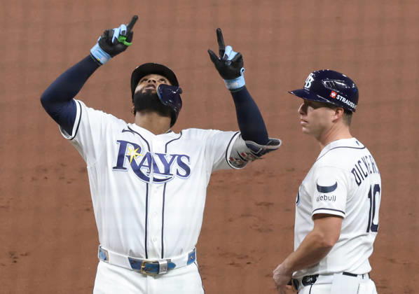 Tampa Bay Rays Junior Caminero (13) reacts on first base next to first base coach Corey Dickerson (10) after hitting an rbi-single against the Cleveland Guardians in the first inning in game one of the MLB, Baseball Herren, USA American League Championship Series playoff at Raymond James Stadium in Tampa, Florida, on Monday, October 12, 2026.  TPB20261012704 GARYxBOGDON
