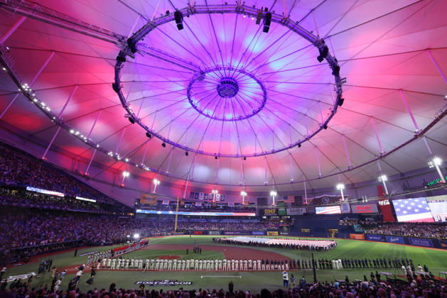 Cleveland Guardians and Tampa Bay Rays players stand on the field for the singing of the National Anthem before the start of their MLB, Baseball Herren, USA American League Championship Series playoff at Raymond James Stadium in Tampa, Florida, on Monday, October 12, 2026.  TPB20261012705 GARYxBOGDON