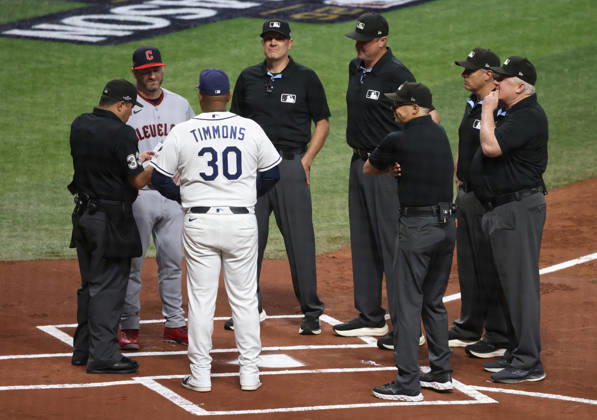 Tampa Bay Rays Ozzie Timmons (30) and Cleveland Guardians manager Stephen Vogt (12) meet with umpires at home plate before the start of their MLB, Baseball Herren, USA American League Championship Series playoff at Raymond James Stadium in Tampa, Florida, on Monday, October 12, 2026.  TPB20261012706 GARYxBOGDON