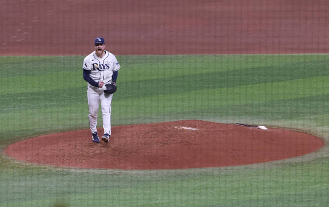 Tampa Bay Rays pitcher Drew Rasmussen (57) reacts after striking out Cleveland Guardians Jose Ramirez in the fifth inning in game one of the MLB, Baseball Herren, USA American League Championship Series playoff at Raymond James Stadium in Tampa, Florida, on Monday, October 12, 2026.  TPB20261012711 GARYxBOGDON