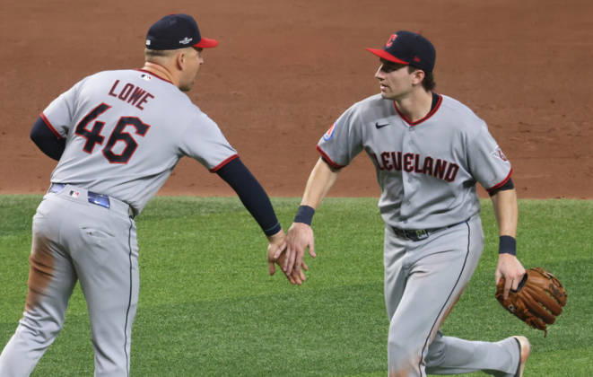 Cleveland Guardians first baseman Nathaniel Lowe (46) and second baseman Travis Bazzana celebrate after the Guardians defeated the Tampa Bay Rays 7-3 in game one of the MLB, Baseball Herren, USA American League Championship Series playoff at Raymond James Stadium in Tampa, Florida, on Monday, October 12, 2026.  TPB202610127121 GARYxBOGDON
