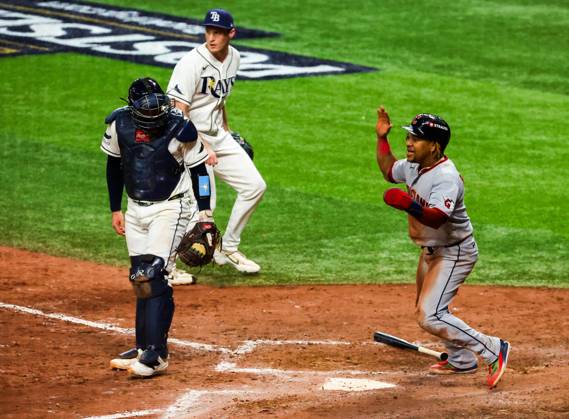 October 12, 2026, St. Petersburg, Florida, USA: Tampa Bay Rays catcher Liam Hicks (34) look on as Cleveland Guardians third baseman Joso RamoÂ­rez (11) celebrates his run and cheers on the next runner Guardians right fielder Chase DeLauter (24) on a Guardians Jo Adell (7) two run double in the ninth inning during the American League Championship Series game 1 at Tropicana Field on Monday, Oct. 12, 2026 in St. Petersburg. St. Petersburg USA - ZUMAs70_ 0869264541st Copyright: xDirkxShaddx