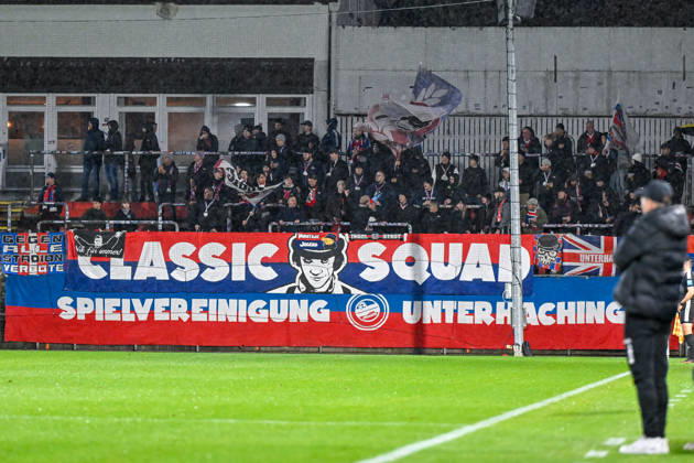 Unterhaching fans wave flags and cheer on their team; fans, crowd, spectators, excitement, atmosphere, stadium, October 13, 2026, Unterhaching, Germany, soccer, Bavarian Regional League, SpVgg Unterhaching vs. TSV 1882 Landsberg xslx
