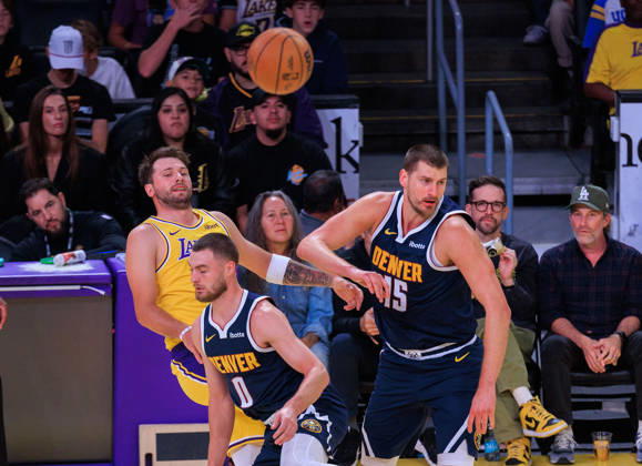 October 16, 2026, Los Angeles, California, USA: Luka Doncic 77 of the Los Angeles Lakers passes away from Nikola Jokic 15 and Christian Braun 0 of the Denver Nuggets battle for the ball during a preseason NBA, Basketball Herren, USA game on Friday, October 16, 2026, at Crypto.com Arena in Los Angeles, California. JAVIER ROJAS PI Lakers Vs. Nuggets - Preseason - ZUMAp124 20261016_zaa_p124_008 Copyright: xJavierxRojasx