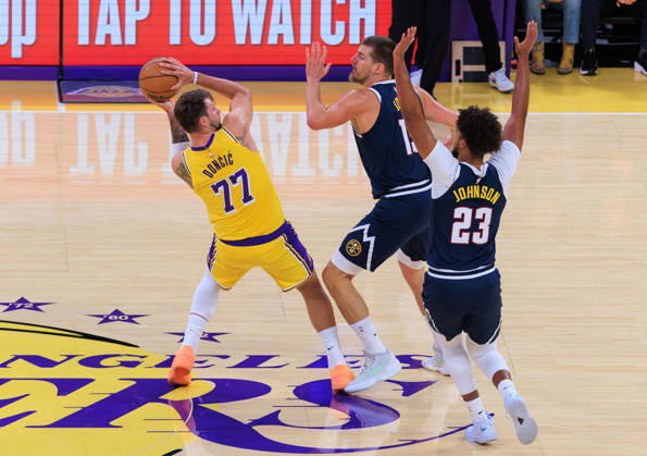October 16, 2026, Los Angeles, California, USA: Luka Doncic 77 of the Los Angeles Lakers is guarded by Nikola Jokic 15 and Cameron Johnson 23 of the Denver Nuggets during a preseason NBA, Basketball Herren, USA game on Friday, October 16, 2026, at Crypto.com Arena in Los Angeles, California. JAVIER ROJAS PI Lakers Vs. Nuggets - Preseason - ZUMAp124 20261016_zaa_p124_011 Copyright: xJavierxRojasx