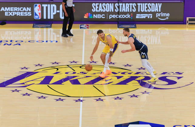 October 16, 2026, Los Angeles, California, USA: Luka Doncic 77 of the Los Angeles Lakers is defended by Christian Braun 0 of the Denver Nuggets during a preseason NBA, Basketball Herren, USA game on Friday October 16, 2026 at Crypto.com Arena in Los Angeles, California. Lakers lose to Nuggets, 106-121. JAVIER ROJAS PI Lakers Vs. Nuggets - Preseason  - ZUMAp124 20261016_zaa_p124_045 Copyright: xJavierxRojasx