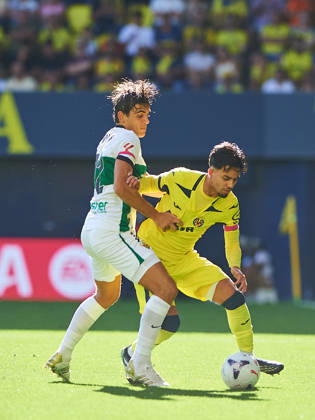 Gonzalo Villar of Elche CF and Ilias Akhomach of Villarreal CF during the LaLiga EA Sports match between Villarreal CF and Elche CF at Estadio de la Cerámica on October 17, 2026, in Villarreal, Spain