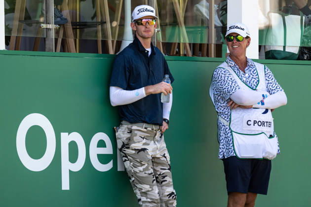 October 18, 2026, Macau, Macao Sar, China: Charles PORTER from the USA takes the tied lead on -14 Par with a stunning -9 Par final round. PORTER and his caddy hide from the heat in the shade of the hospitality stand on the 18th green. Macau Open Golf 2026 Final Round. Macau Open Golf 2026 Final Round  - ZUMAr144 20261018_zap_r144_043 Copyright: xJaynexRussellx