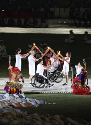 (261018) -- NAGOYA, Oct. 18, 2026 -- Torch bearers hand over the flame during the opening ceremony of the Aichi-Nagoya Asian Para Games in Nagoya, Japan, Oct. 18, 2026. ) (SP)JAPAN-NAGOYA-ASIAN PARA GAMES-OPENING CEREMONY YaoxQilin 
