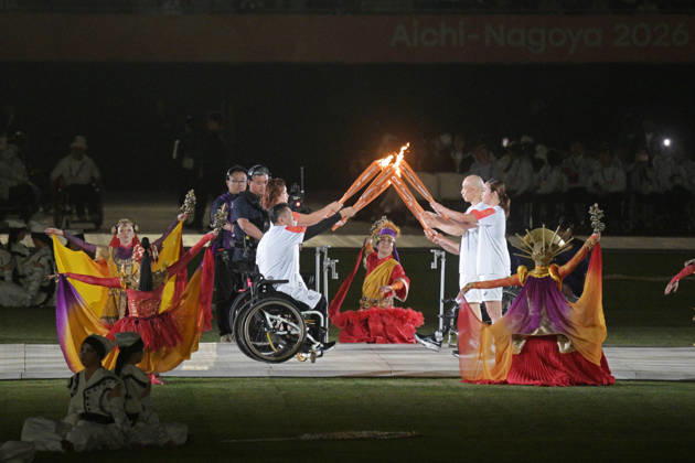 (261018) -- NAGOYA, Oct. 18, 2026 -- Torch bearers hand over the flame during the opening ceremony of the Aichi-Nagoya Asian Para Games in Nagoya, Japan, Oct. 18, 2026. ) (SP)JAPAN-NAGOYA-ASIAN PARA GAMES-OPENING CEREMONY ThenxChihxWey 