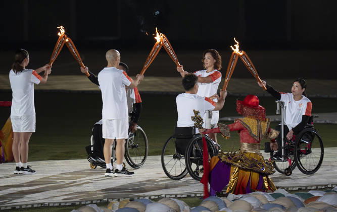 (261018) -- NAGOYA, Oct. 18, 2026 -- Torch bearers hand over the flame during the opening ceremony of the Aichi-Nagoya Asian Para Games in Nagoya, Japan, Oct. 18, 2026. ) (SP)JAPAN-NAGOYA-ASIAN PARA GAMES-OPENING CEREMONY CaixYang 