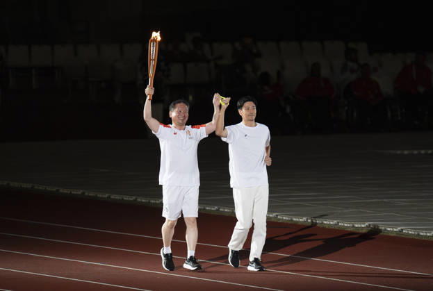 (261018) -- NAGOYA, Oct. 18, 2026 -- Torch bearers relay the torch during the opening ceremony of the Aichi-Nagoya Asian Para Games in Nagoya, Japan, Oct. 18, 2026. ) (SP)JAPAN-NAGOYA-ASIAN PARA GAMES-OPENING CEREMONY CaixYang 