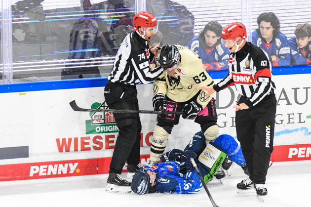 Straubing Tigers vs. Grizzlys Wolfsburg, Ice Hockey, German Ice Hockey League, Penny DEL, Matchday 10, 2026–2027 Season, October 18, 2026: Jamieson Rees of the Straubing Tigers lies on the ice in front of Luis Schinko of the Grizzlys Wolfsburg, Men’s Ice Hockey, German Ice Hockey League, Penny DEL, Matchday 10, 2026–2027 Season on October 18, 2026, at the Eisstadion am Pulverturm, Straubing Tigers (blue) vs. Grizzlys Wolfsburg (beige)