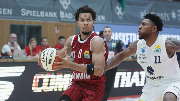 Pictured from left: Brandon Tischler of Würzburg Baskets, No. 8, with the ball against Anthony Gaines of Syntainics MBC, No. 11, 18, 10, 2026, Fitness First Würzburg Baskets vs. SYNTAINICS MBC, Netto BBL Cup, Round of 16, Germany, 97072, tectake Arena Würzburg, Copyright: HMBxMedia xJulienxBecker