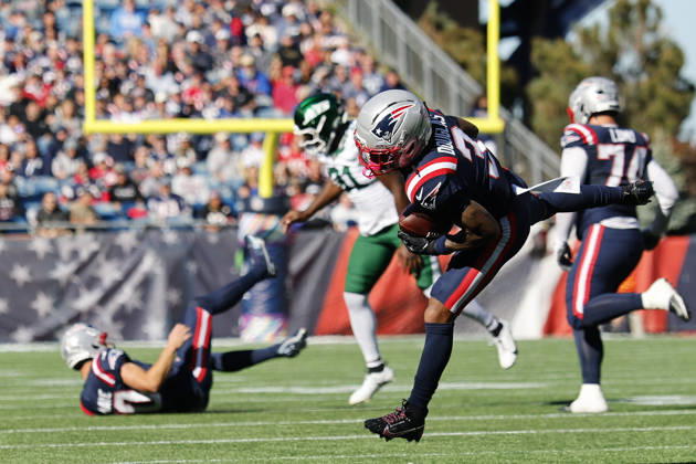 New England Patriots wide receiver DeMario Douglas, right, makes a catch as New England Patriots quarterback Drake Maye, left, is knocked down by New York Jets linebacker David Bailey, center, during the first half at Gillette Stadium in Foxborough, Massachusetts on Sunday, October 18, 2026. BOP20261018008 CJxGUNTHER