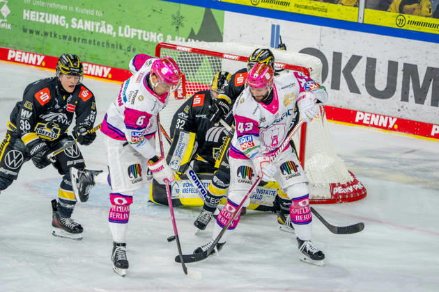October 18, 2026, xkkux, Ice Hockey, DEL, Krefeld Pinguine vs. Eisbären Berlin, 2026–27 Season, YAYLA Arena, Krefeld: Andreas Eder (Eisbären Berlin, 43) and Kai Wissmann (Eisbären Berlin, 06) in front of the net defended by goalie Juha Jatkola (Krefeld Pinguine, 32), next to Tim Schütz (Krefeld Pinguine, 38), North Rhine-Westphalia, Germany
