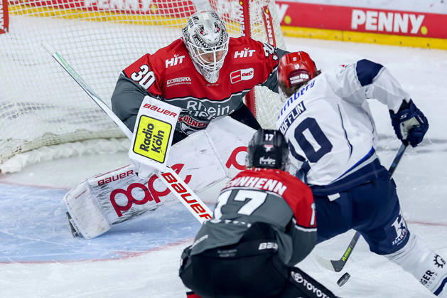 October 20, 2026, Ice hockey, DEL, Kölner Haie vs. Schwenninger Wild Wings, Matchday 49, 2026–27 season, Lanxess Arena, Cologne. Goalie Janne Juvonen of the Kölner Haie (No. 30) defends the net against Mirko Höfflin of the SWW (No. 10), North Rhine-Westphalia, Germany
