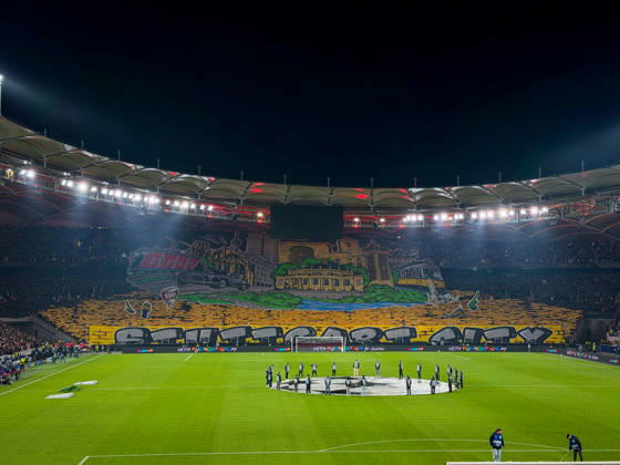Germany, Soccer, 2026–2027 UEFA Champions League, Matchday 3, VfB Stuttgart vs. Atlético Madrid, October 20, 2026, Stuttgart Arena, interior view; wide shot of the illuminated soccer stadium from behind the goal before kickoff; large fan choreography by VfB supporters in the Cannstatter Kurve; packed stands; spectators; fans; floodlights; stadium roof; playing field; center circle; Champions League anthem, player entrance ceremony, fan section, atmosphere, home game, UEFA, Champions League, advertising, sponsors Copyright: xBENEDICTxCHRISTx