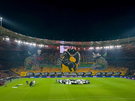 Germany, Soccer, 2026–2027 UEFA Champions League, Matchday 3, VfB Stuttgart vs. Atlético Madrid, October 20, 2026, Stuttgart Arena, interior view; wide shot of the illuminated soccer stadium from behind the goal before kickoff; large fan choreography by VfB supporters in the Cannstatter Kurve; packed stands; spectators; fans; floodlights; stadium roof; playing field; center circle; Champions League anthem, player entrance ceremony, fan section, atmosphere, home game, UEFA, Champions League, advertising, sponsors Copyright: xBENEDICTxCHRISTx