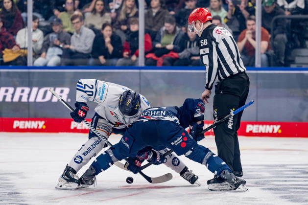Linesman Yannik Koziol officiates a faceoff between Justin Scott of the Iserlohn Roosters, 20, and Patrick Hager of EHC Red Bull Munich, 52 (GER), EHC Red Bull Munich vs. Iserlohn Roosters, DEL, 2026–2027 season, Matchday 11, October 23, 2026. Photo: HMB Media, Franz Feiner Copyright: HMBxMedia FranzxFeiner