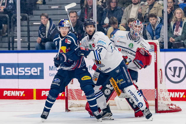 Cole Maier of the Iserlohn Roosters, No. 14, defends against Elis Hede of the EHC Red Bull Munich, No. 10, in front of the net of Andreas Jenike, goaltender for the Iserlohn Roosters, No. 92, GER, EHC Red Bull Munich vs. Iserlohn Roosters, DEL, 2026–2027 season, Matchday 11, October 23, 2026. Photo: HMB Media, Franz Feiner Copyright: HMBxMedia FranzxFeiner