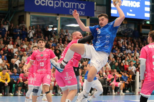 October 24, 2026 Men s Handball 2026–2027, 2nd Division, Matchday 9: Dessau Roßlauer HV 06 vs. SC DHfK Leipzig, Anhalt Arena, Dessau. Marcel Nowak (Dessau, 15, blue) is tackled by Moritz Preuss (Leipzig, 67, pink, in Dessau Roßlau, Saxony-Anhalt, Germany