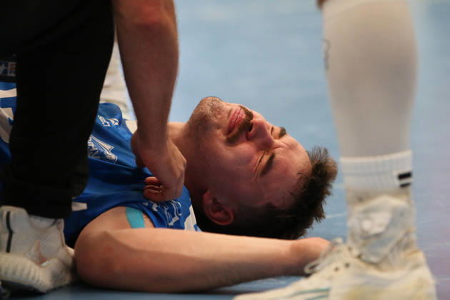 October 24, 2026 Men s Handball 2026–2027, 2nd Division, Matchday 9: Dessau Roßlauer HV 06 vs. SC DHfK Leipzig at Anhalt Arena, Dessau. Marcel Nowak, Dessau, 15, in blue, is lying on the ground after a rough foul and is receiving medical attention Dessau Roßlau Saxony-Anhalt Germany