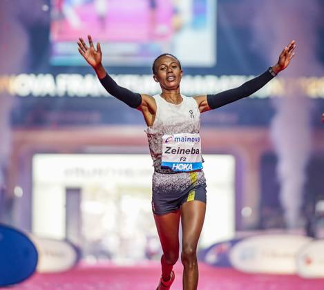 Ethiopian Zeineba Yimer Wins the Mainova Frankfurt Marathon in 2:19:45:25:10:26—A Triumphant Finish at the Festhalle. Zeineba Yimer of Ethiopia wins the women’s race at the Mainova Frankfurt Marathon with a winning time of 2:19:45 hours Frankfurt Festhalle Hesse Germany JRW02162