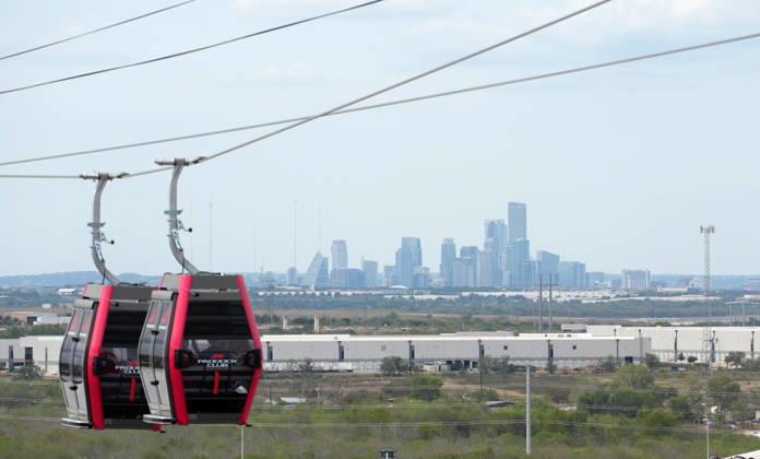 October 25, 2026, Circuit of The Americas, Austin, 2026 FORMULA 1 MSC CRUISES UNITED STATES GRAND PRIX, Shuttles travel back and forth between the main building in the paddock and the new station at the first turn, with the Austin skyline in the background. Photo by Hasan Bratic, DeFodi Images