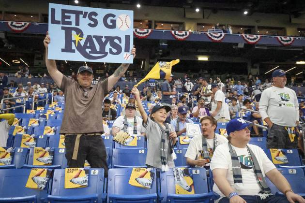 October 26, 2026, St. Petersburg, Florida, USA: BILL JOHNSON, left, and his son, LIAM JOHNSON, 8, both of Raleigh, N.C., show their support for the Tampa Bay Rays during warmups before Game 3 of the World Series between the Tampa Bay Rays and the Milwaukee Brewers at Tropicana Field in St. Petersburg. St. Petersburg USA - ZUMAs70_ 20261026_zan_s70_033 Copyright: xDouglasxR.xCliffordx