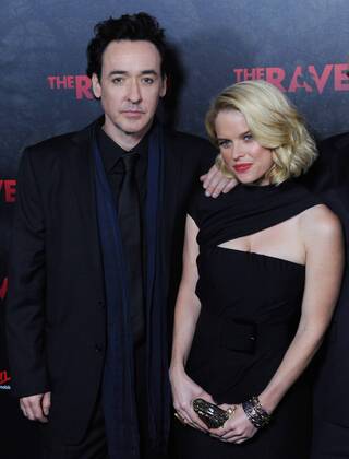 Actor John Cusack (L) and Alice Eve, cast members in the motion picture mystery thriller The Raven , attend the premiere of the film at the Los Angeles Theatre in the downtown section of Los Angeles on April 23, 2012.  LAP2012042308