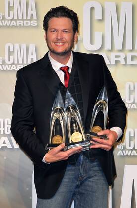 Blake Shelton, winner of Entertainer of the Year, Male Vocalist of the Year and Song of the Year, poses with his trophies backstage at the 2012 Country Music Awards at the Bridgestone Arena in Nashville on November 1, 2012.  CMA20121101164