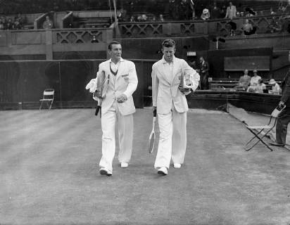 Fred Perry took the first set from D Budge of America 6-0 when they met in the second singles match of the Davis Cup challenge round at Wimbledon Photo shows Perry and Budge going onto the court 27th July 1935  UnitedArchives00953657