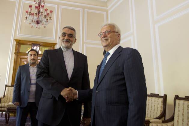 Iranian Chairman of the Parliament National Security and Foreign Policy Committee Alaeddin Boroujerdi (L) greets Hannes Swoboda, head of a European Parliament delegation, in Tehran, Iran on October 20, 2013. The delegation is expected to meet a number senior Iranian officials to explore bilateral relations.  IRN20131020102