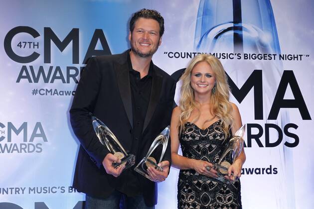 Blake Shelton, winner of Male Vocalist of the Year, and his wife Miranda Lambert, winner of Female Vocalist of the Year, poses backstage during the 47th Annual Country Music Awards at Bridgestone Arena in Nashville on November 6, 2013.  CMA20131106312