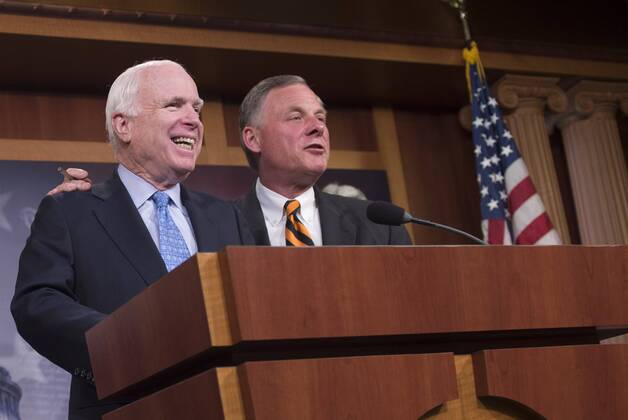 Sen. John McCain (R-AZ) and Sen. Richard Burr (R-NC) joke together during a press conference on the proposed Veterans Affairs bill, on Capitol Hill in Washington, D.C. on June 3, 2014.  WAP20140603356