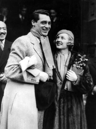 Feb. 9, 1934 - London, England, U.K. - British-born actor CARY GRANT (born Archibald Leach) with VIRGINIA CHERRILL after their wedding in London. Grant escaped his humble Bristol environs and unstable home life by joining an acrobatic troupe, where he became a stilt-walker. Numerous odd jobs kept him going until he tried acting, and, after moving to the United States, he managed to lose his accent, developing a clipped mid-Atlantic speaking style uniquely his own. He was noted as perhaps the foremost exemplar of the debonair leading man, handsome, witty and charming. He was named the second Greatest Male Star of All Time of American cinema by the American Film Institute. London United Kingdom - ZUMAk09