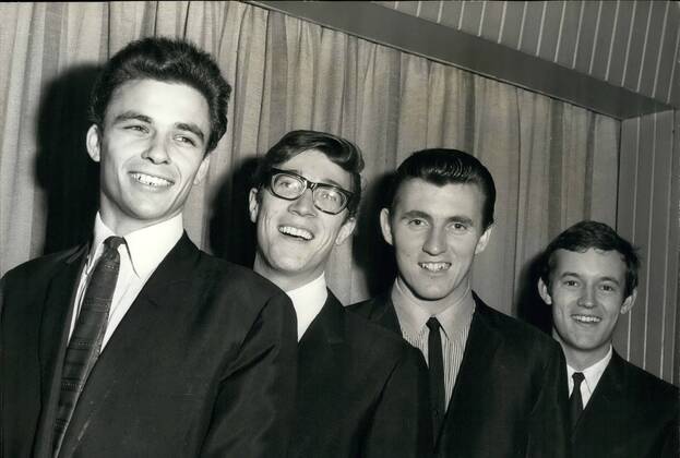 Nov. 11, 1963 - New Shadow meets the Group: 21 year old John Rostill has joined the famous Shadows instrumental group as bass guitarist in place of Brian Liquorice Locking who has left to device more time to his religion. John Rostill is a former pupil of Rutlish School. Photo shows John Rostill (left) meets the rest of the group (left to right) Hank B. Marvin, Bruce Welch and Brian Bennett.  - ZUMAk09