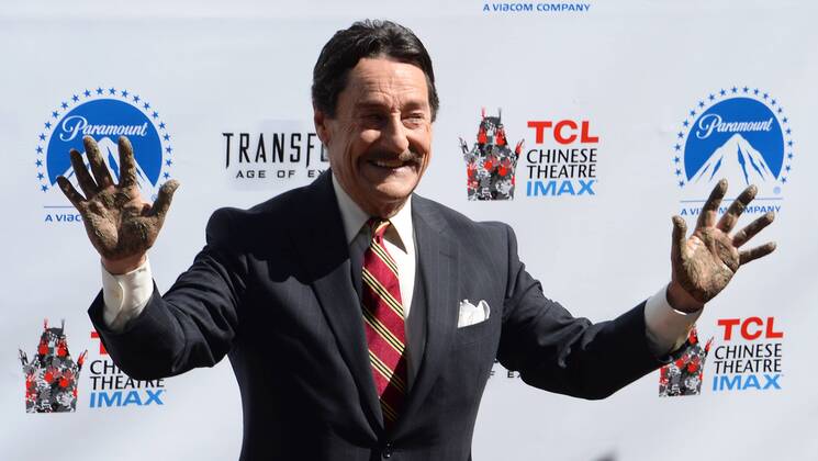 Canadian voice actor Peter Cullen raises his hands during a handprint ceremony beside Optimus Prime from the $1 billion worldwide blockbuster film Transformers: Age of Extinction , unveiled outside the TCL Chinese Theater in the Hollywood section of Los Angeles on September 30, 2014. Optimus Prime, the heroic leader of the Autobots was immortalized with the traditional ceremony for Hollywood stars while Cullen, who is the voice of Optimus Prime, got to dip his hands in the cement.  LAP2014093010